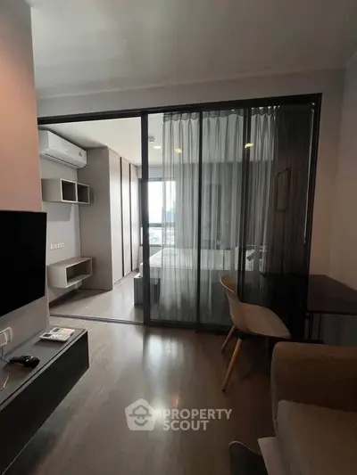 Modern apartment interior with glass partition and sleek furnishings