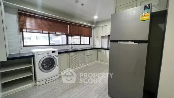 Spacious kitchen with modern appliances and ample storage in a stylish apartment.