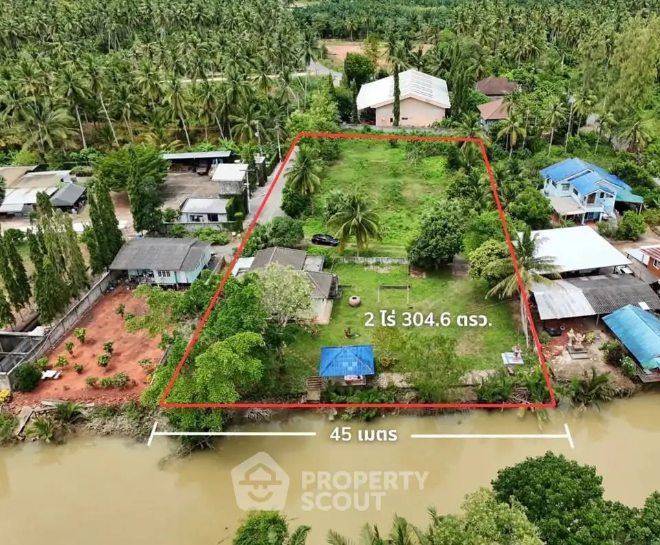 Expansive land plot with lush greenery and riverfront view, ideal for development or investment opportunities.