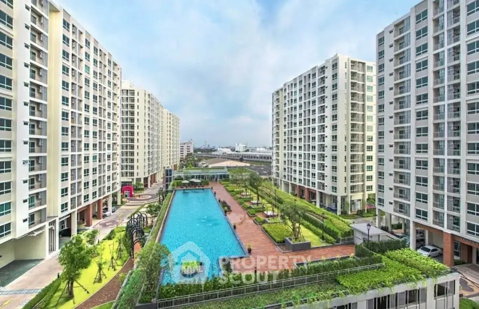 Luxurious condominium complex with stunning pool and landscaped gardens