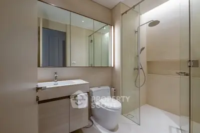 Modern bathroom with sleek fixtures and glass shower enclosure