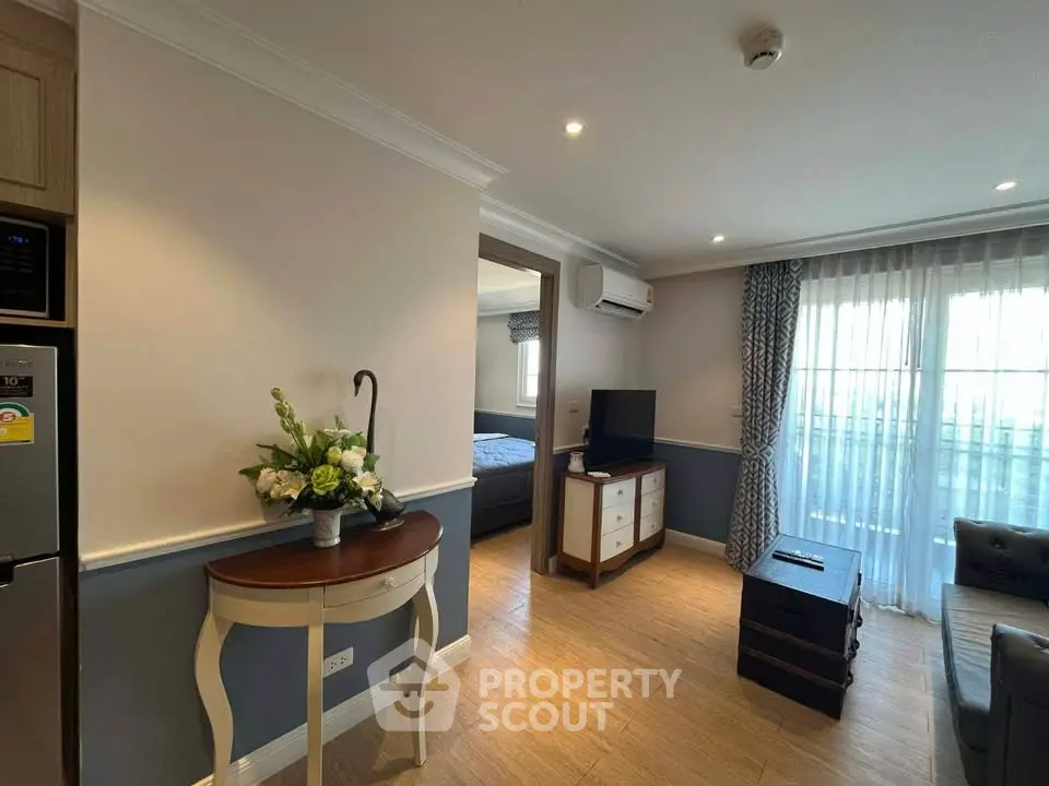 Charming living room with elegant decor and natural light, featuring a cozy seating area and stylish furnishings.