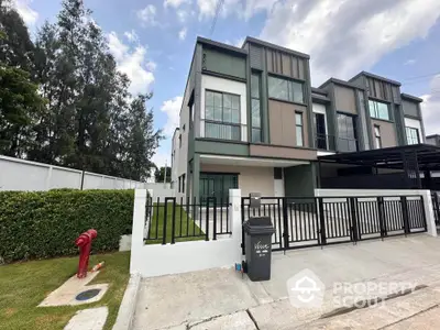 Modern townhouse exterior with sleek design and spacious driveway