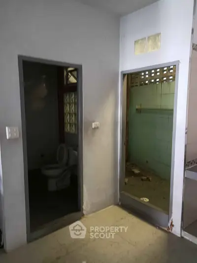 Spacious bathroom with separate toilet and shower area, ideal for renovation.