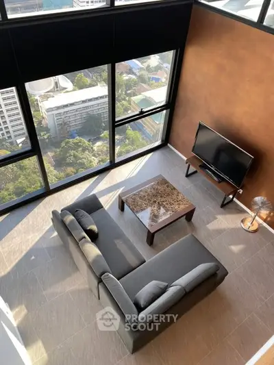 Stunning high-rise living room with panoramic city views and modern furnishings.
