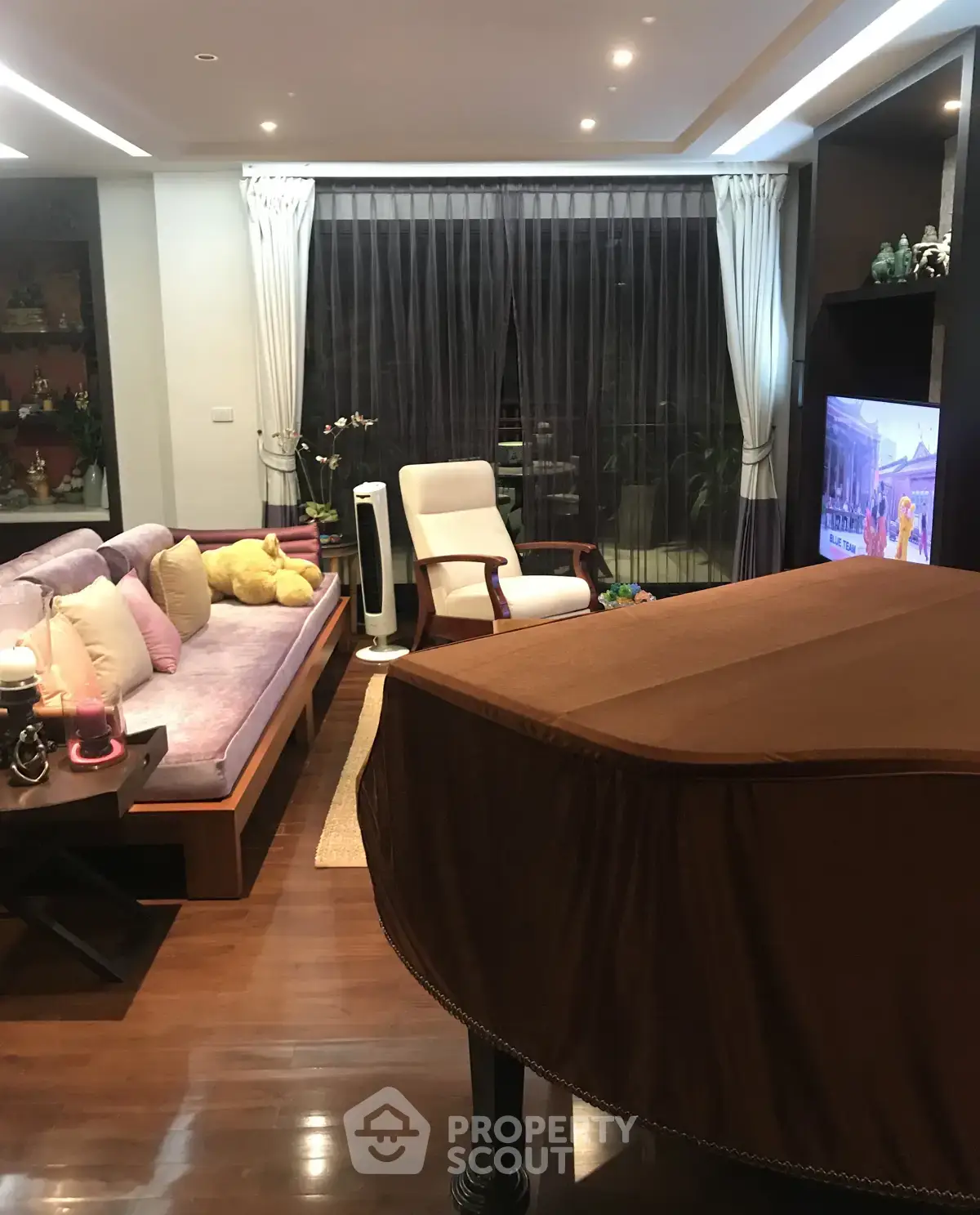 Luxurious living room with elegant decor and grand piano, perfect for entertaining guests.