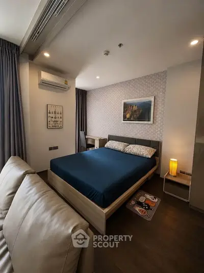 Cozy bedroom with modern decor and comfortable furnishings in a stylish apartment.