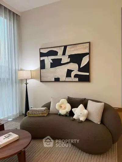 Stylish living room with modern art and cozy seating in a contemporary apartment.