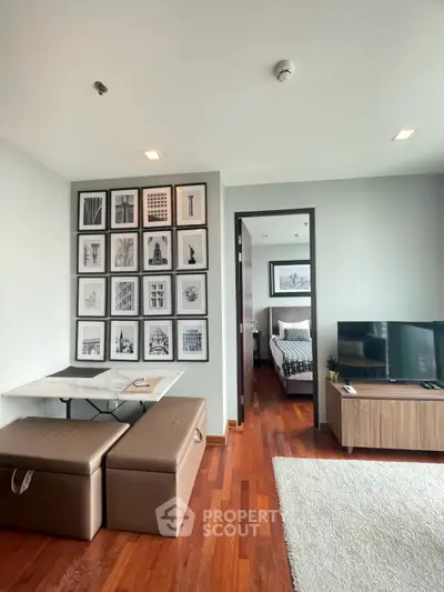 Modern living room with stylish decor and cozy bedroom view, perfect for urban living.