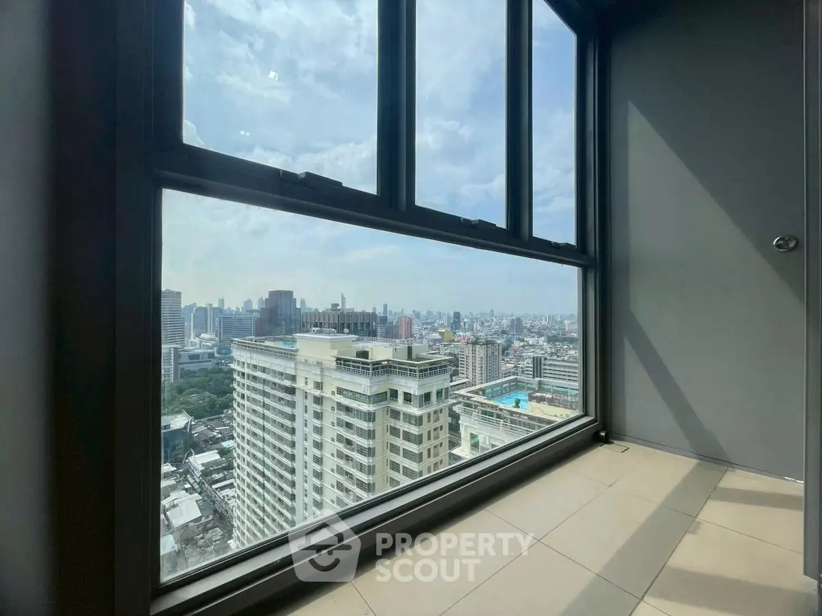 Stunning high-rise city view from a modern apartment window, showcasing urban skyline.