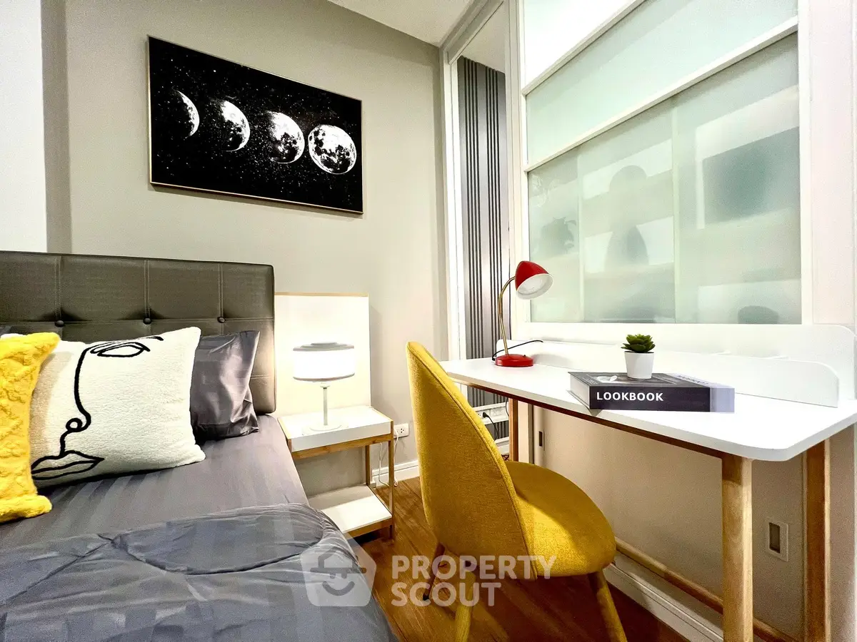 Modern bedroom with stylish decor and cozy workspace