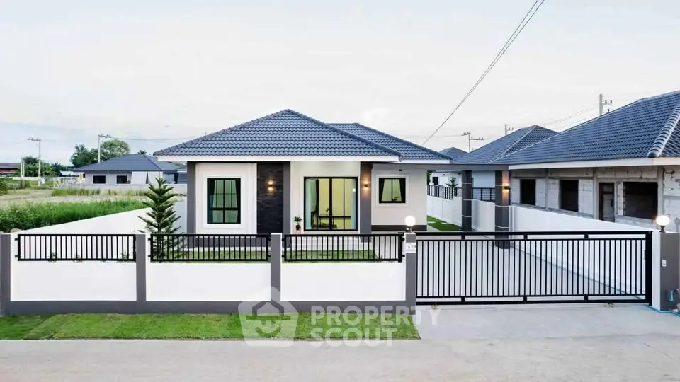 Modern single-story house with sleek design and spacious front yard