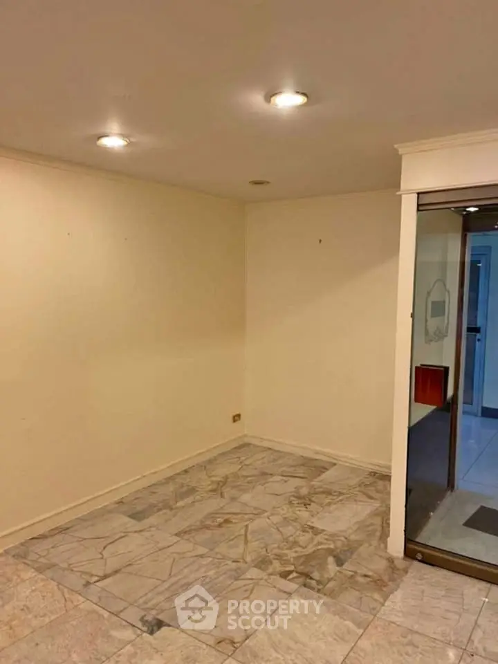 Spacious interior with marble flooring and recessed lighting, ideal for customization.