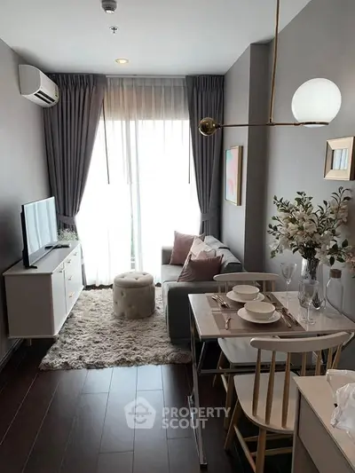 Chic modern living room with cozy decor and elegant dining area in a stylish apartment.