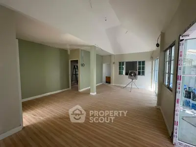 Spacious open-plan living area with large windows and modern flooring, perfect for customization.