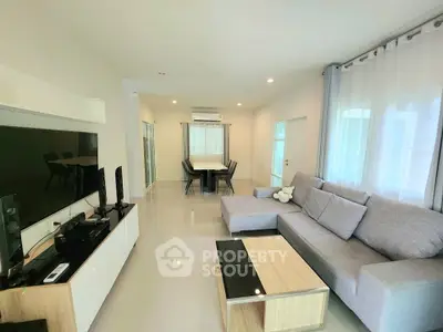 Spacious modern living room with sleek furniture and large windows