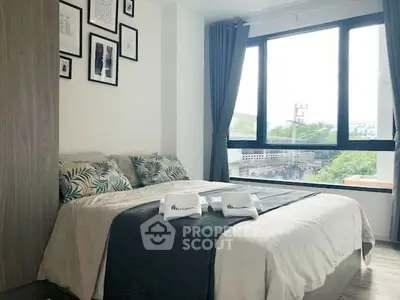 Bright and cozy bedroom with large window and stylish decor