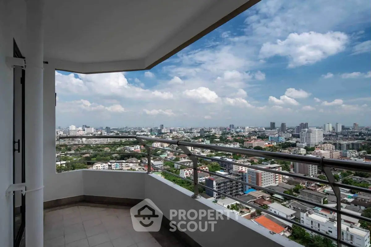 Stunning cityscape view from a spacious balcony in a high-rise apartment.