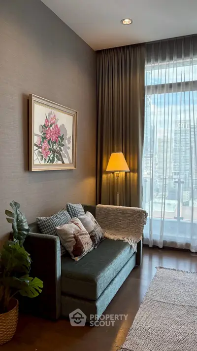 Cozy living room with elegant decor and city view, featuring a plush sofa and stylish floor lamp.