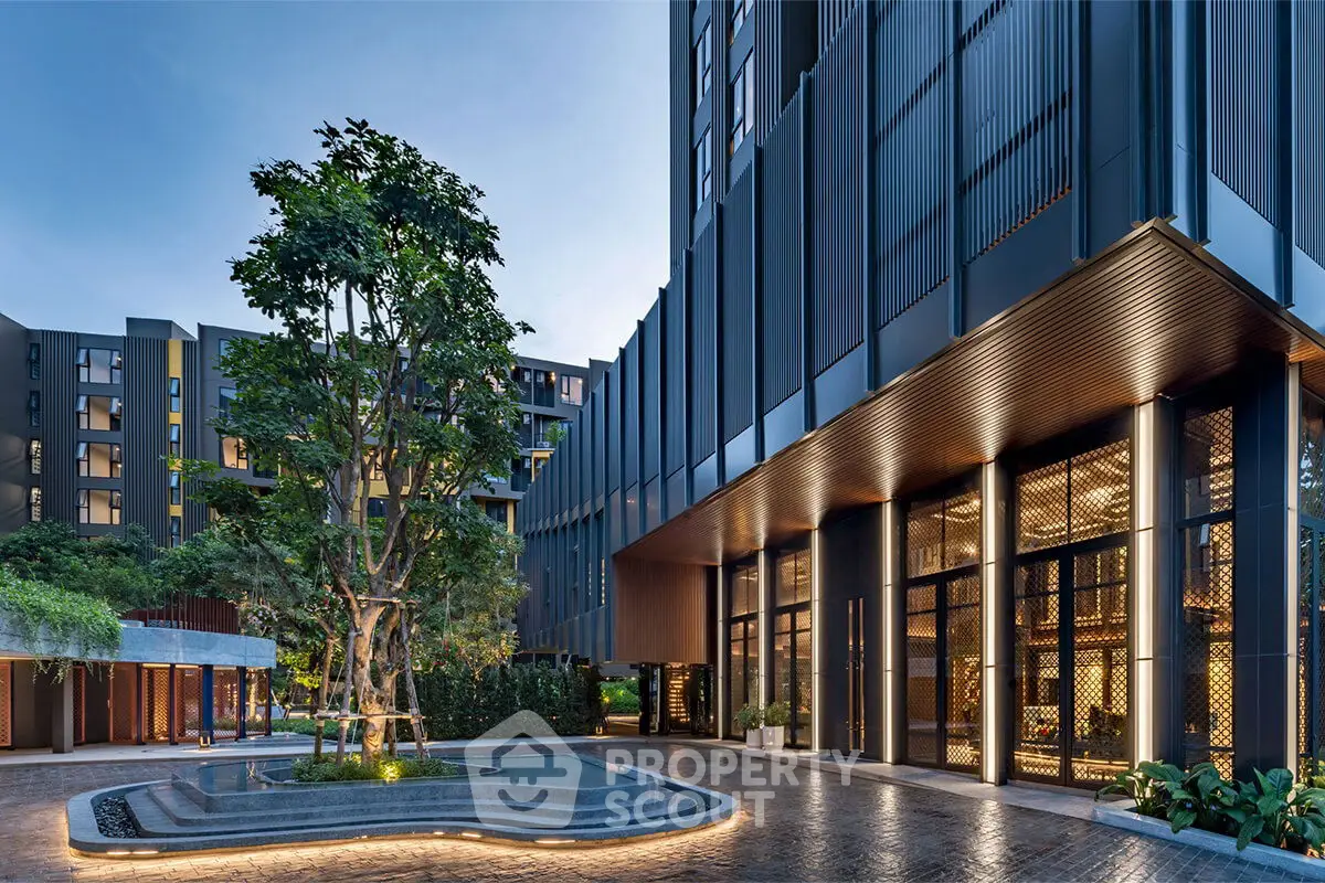 Stunning modern building entrance with elegant design and lush greenery, perfect for luxury living.