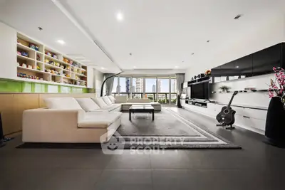 Spacious modern living room with sleek design and city view, featuring a large sofa and entertainment center.