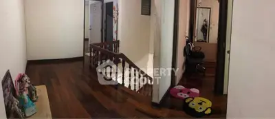 Charming interior hallway with wooden flooring and decorative elements, perfect for family living.