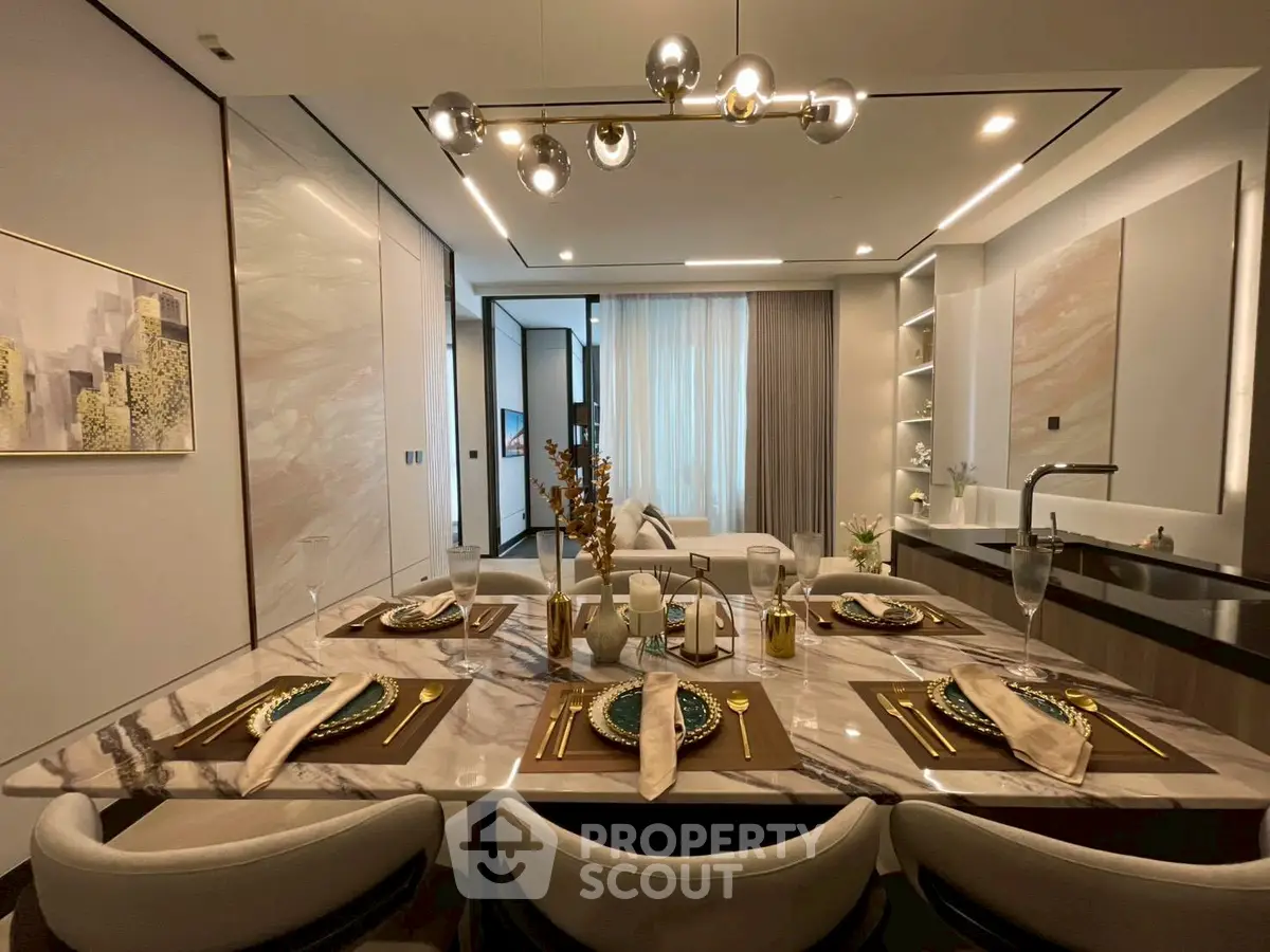 Luxurious open-plan living and dining area with elegant decor and modern lighting