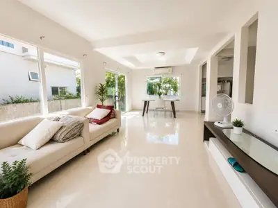 Spacious modern living room with large windows and elegant decor