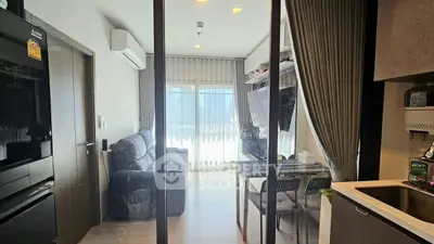 Modern living room with glass partition and cozy seating area