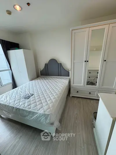 Cozy bedroom with stylish wardrobe and natural light