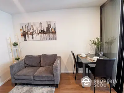 Modern living room with cozy sofa and dining area in stylish apartment.