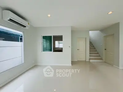 Spacious modern living room with sleek tile flooring and air conditioning