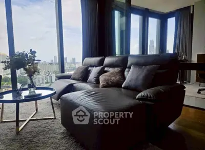 Luxurious living room with panoramic city view and elegant furnishings.