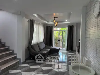 Spacious modern living room with stylish decor and large windows for natural light.