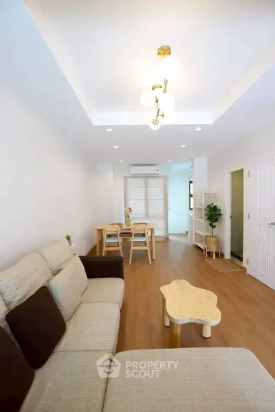 Spacious modern living room with cozy seating and elegant lighting