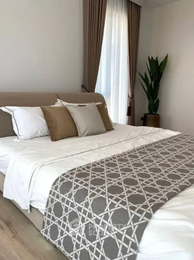 Elegant bedroom with cozy bedding and natural light