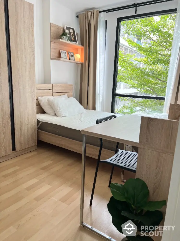 Cozy bedroom with natural light and modern wooden furniture