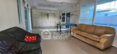 Spacious living room with large windows and comfortable sofas