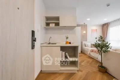 Modern open-plan living room with stylish kitchenette and cozy decor