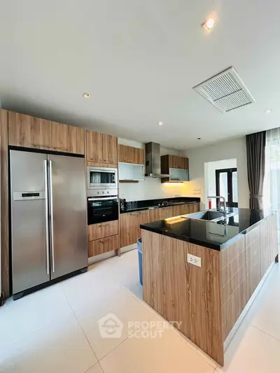 Modern kitchen with sleek wooden cabinets and stainless steel appliances