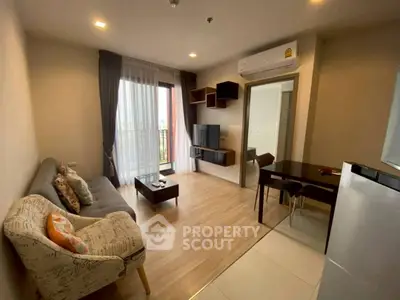 Modern living room with cozy sofa, stylish decor, and natural light from large window.