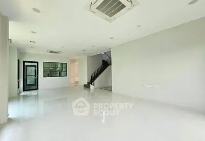 Spacious modern living room with sleek design and ample natural light, perfect for family gatherings.