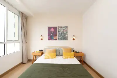 Bright and cozy bedroom with modern decor and large window for natural light.
