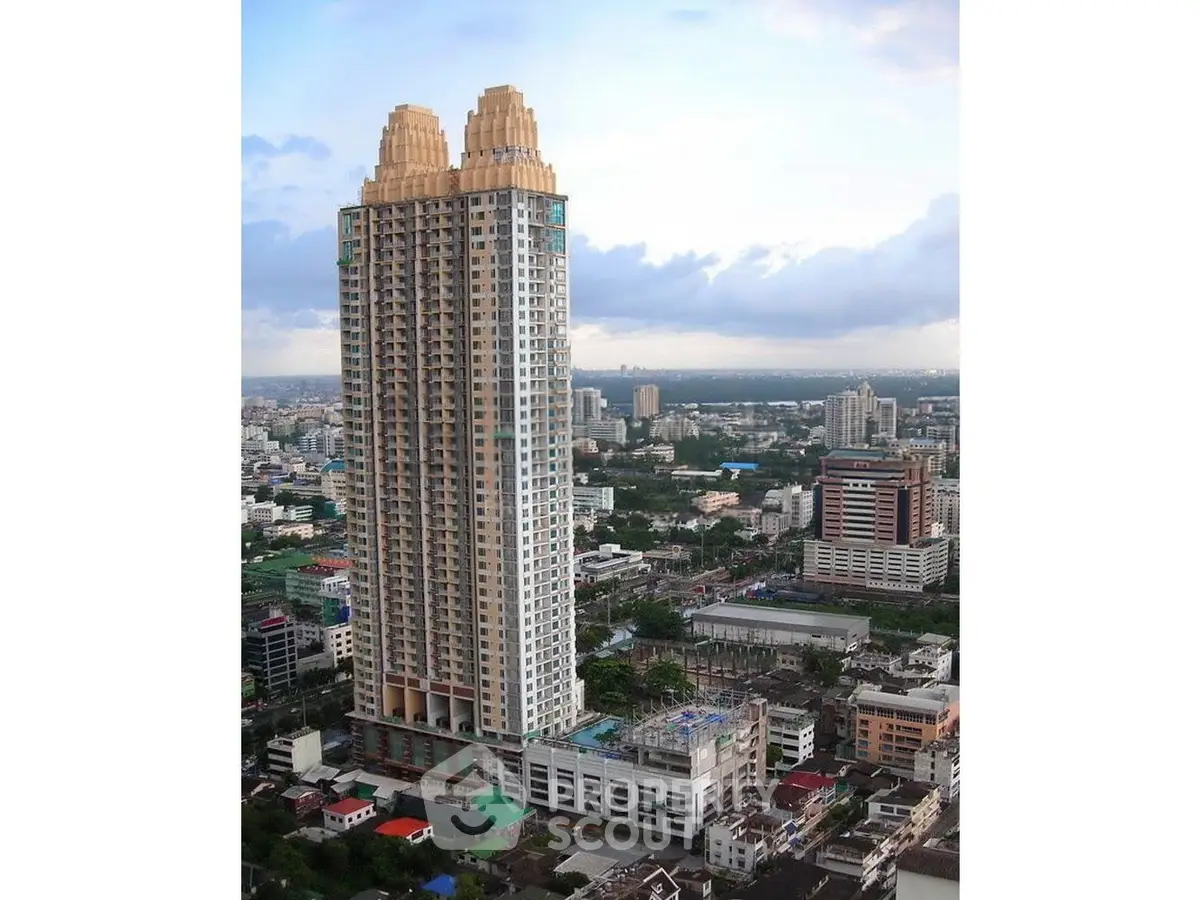 Stunning high-rise building with unique architectural design in vibrant cityscape.