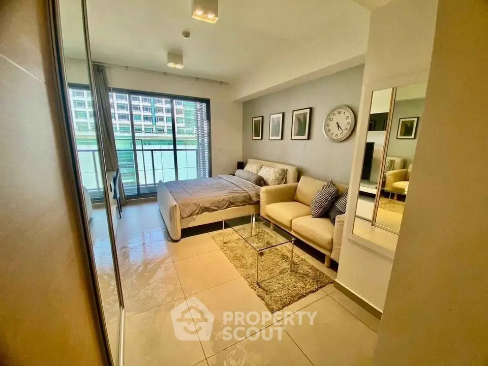 Modern bedroom with cozy seating area and large window view