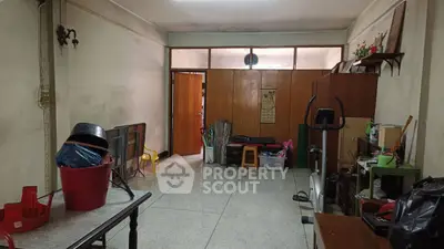 Spacious storage room with exercise equipment and ample shelving.