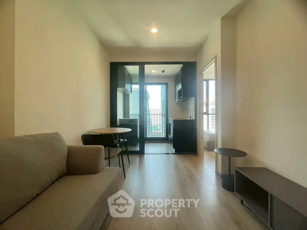 Modern living room with open kitchen and city view balcony