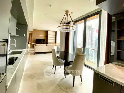 Luxurious open-plan kitchen and dining area with city view, featuring modern appliances and elegant decor.