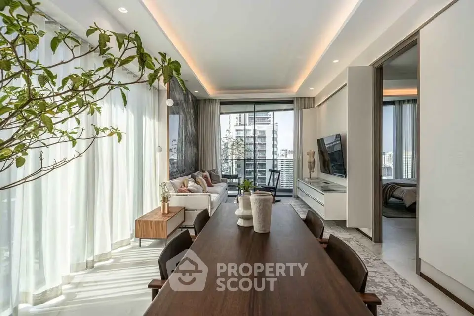 Luxurious modern living room with elegant dining area and large windows offering stunning city views.