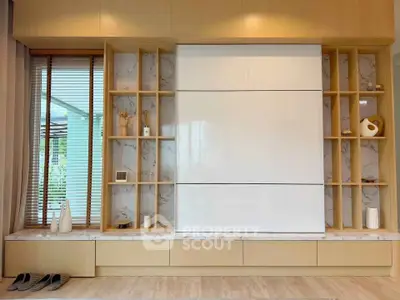 Modern living room with stylish built-in storage and elegant decor
